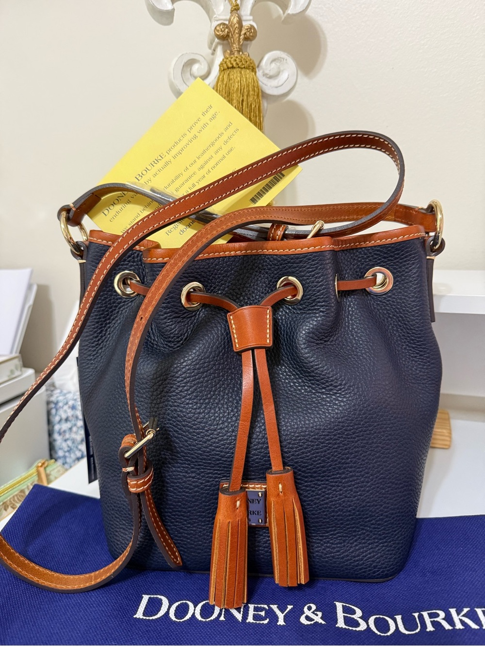Dooney & Bourke Navy and Tan Pebbled Leather Drawstring Crossbody